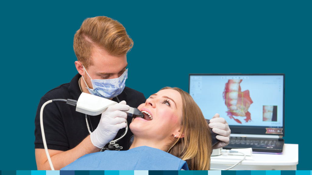 dentist using intraoral scanner on patient